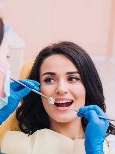 dentist-examining-teeth-female-patient