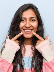 young-fashion-indian-woman-smiles-pointing-fingers-mouth