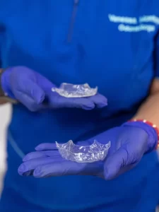 closeup-dentist-holding-retainer-oral-treatment-her-office